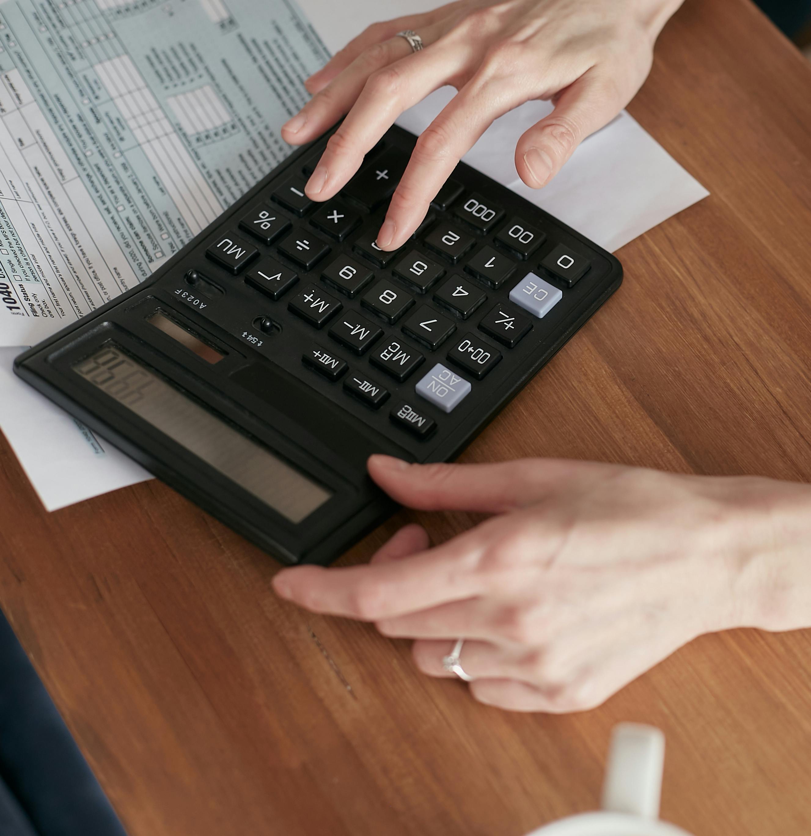Calculator with Philippine tax brackets and financial documents