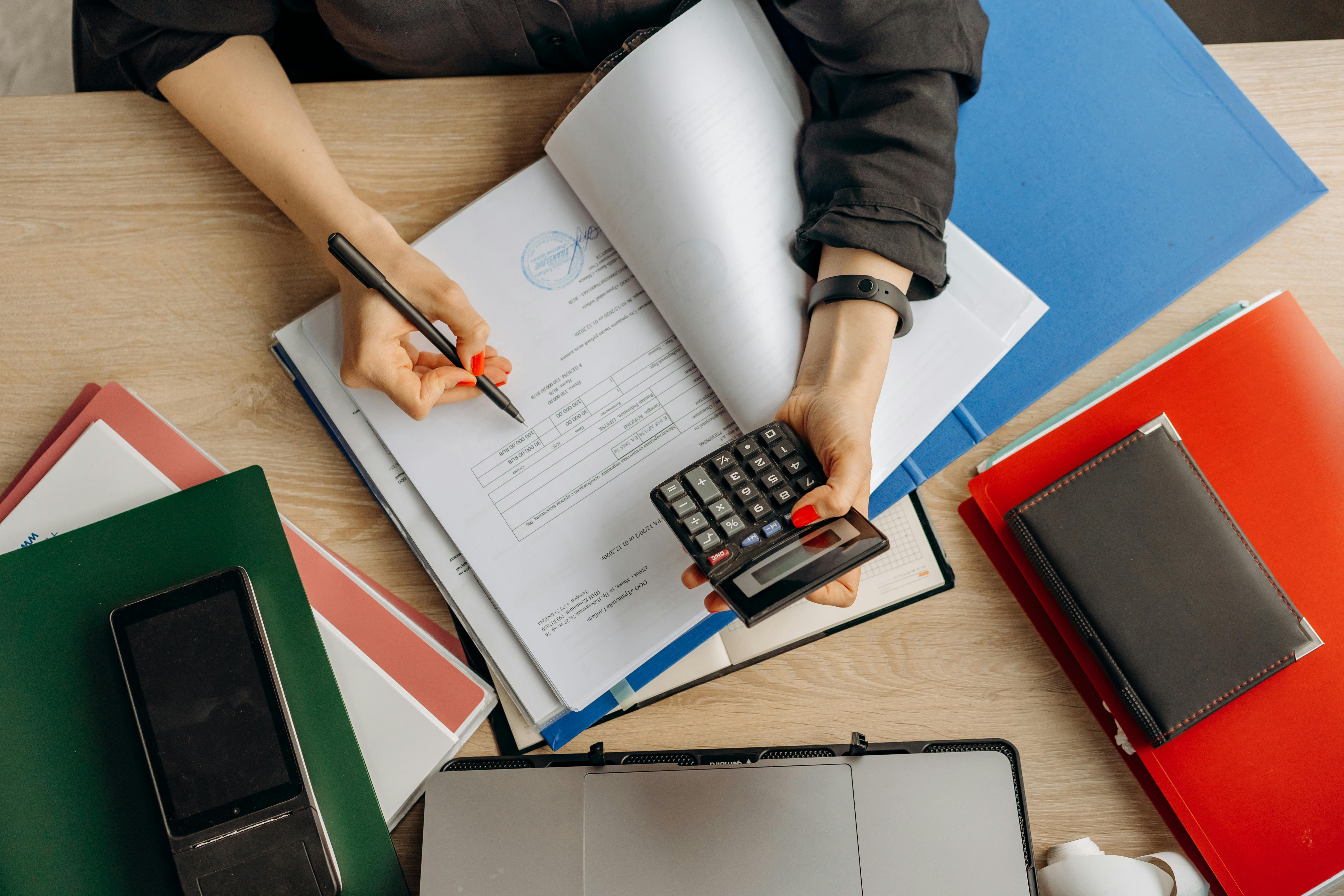 Calculator on financial documents showing tax deductions