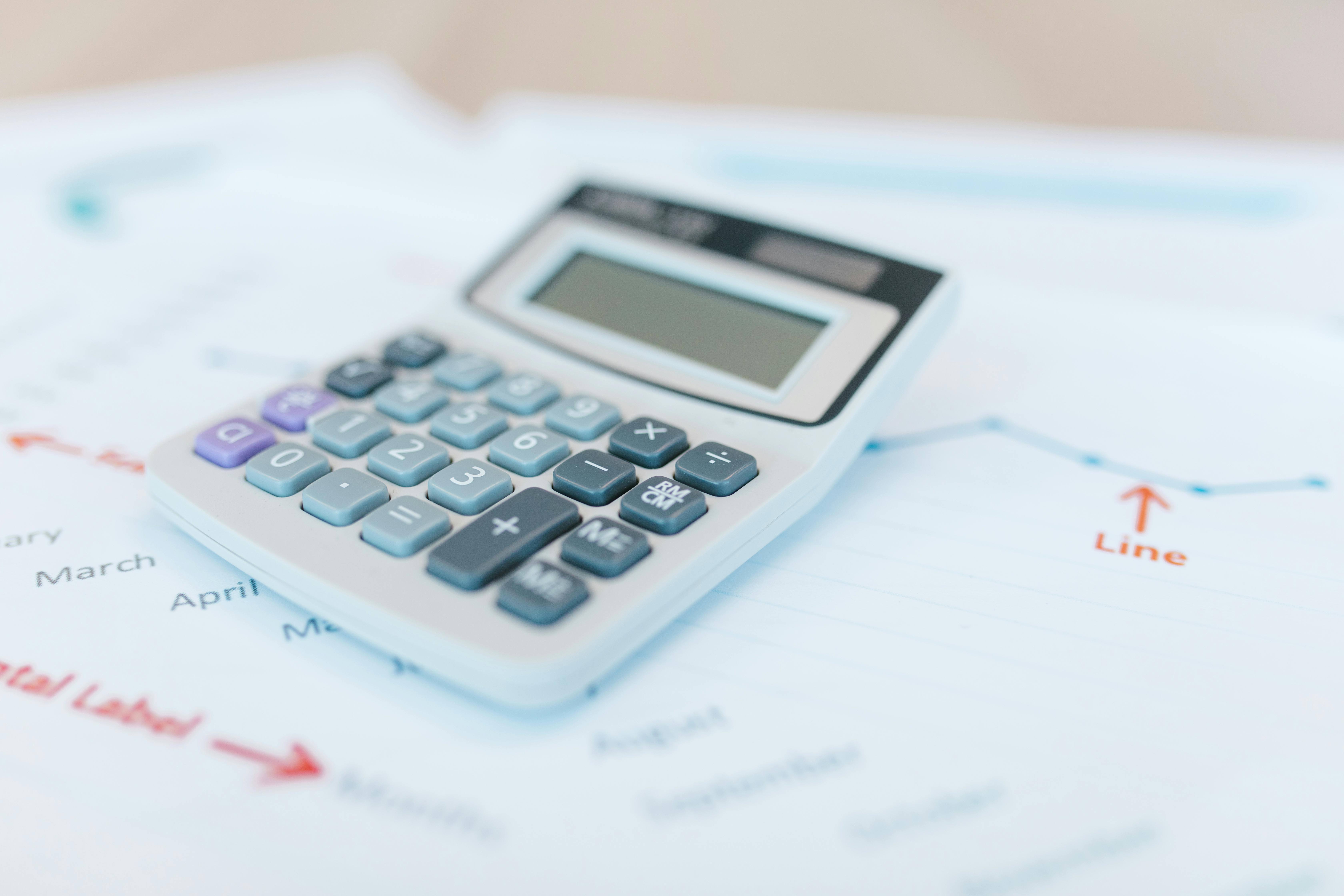 Tax forms with magnifying glass and currency for detailed analysis